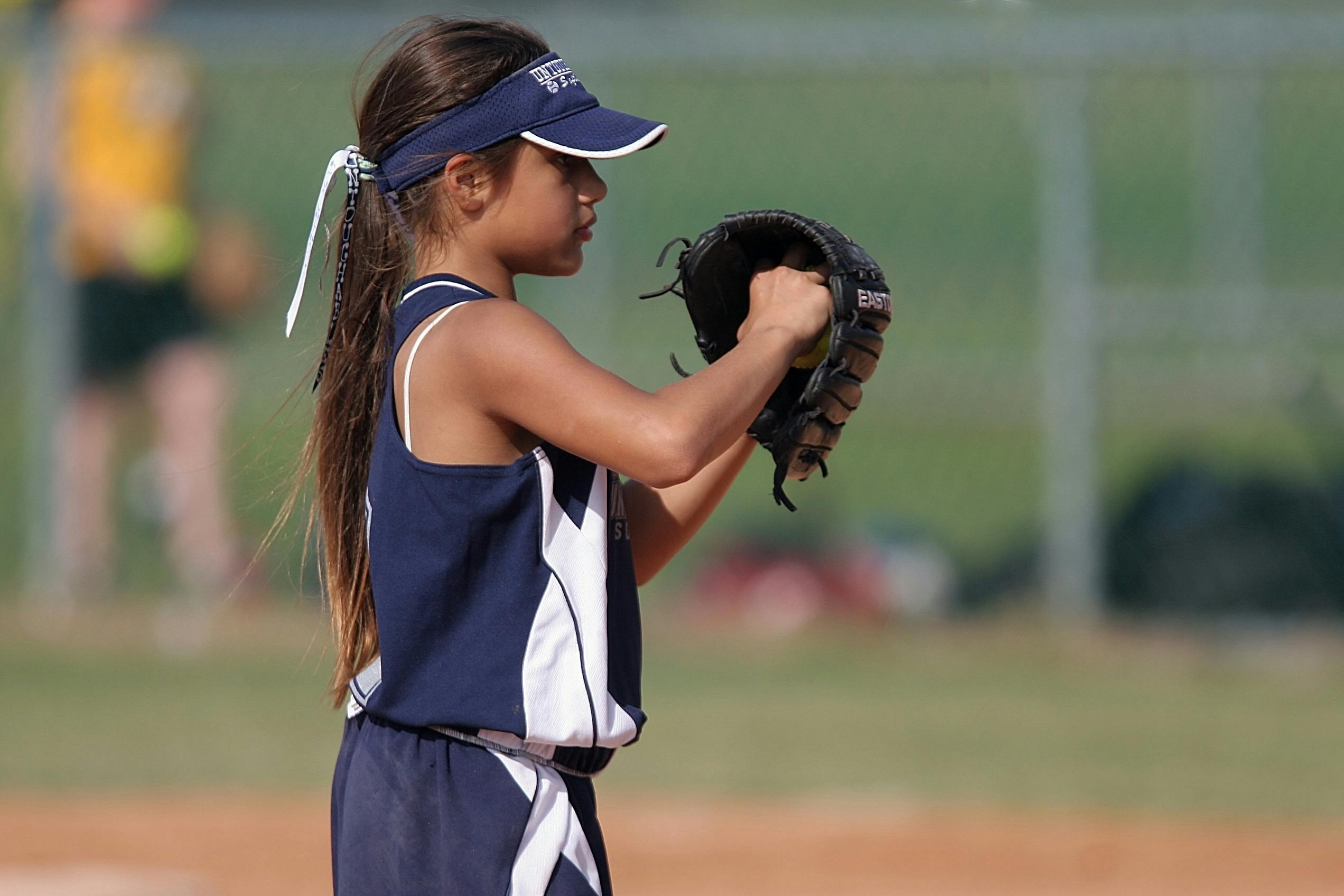 girl getting ready to pitch a baseball